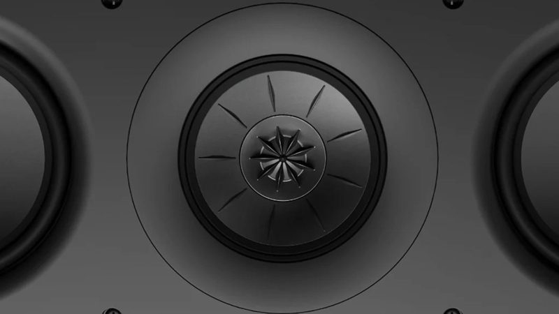 A sleek in-wall KEF architectural speaker mounted flush in drywall, showing the ultra-thin bezel and paintable grille blending with modern interior.