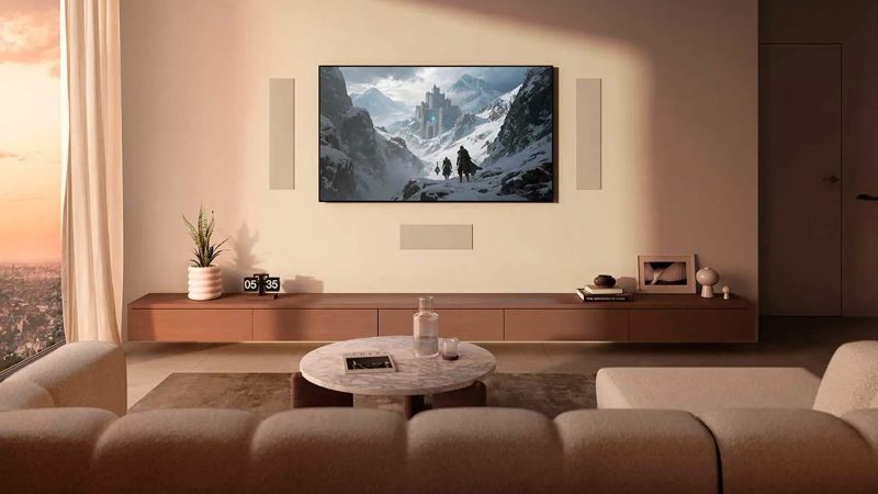 A sleek in-wall KEF architectural speaker mounted flush in drywall, showing the ultra-thin bezel and paintable grille blending with modern interior.