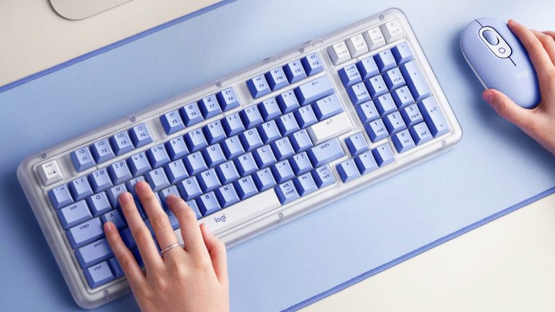 The Logitech Alto Keys K98M mechanical keyboard features translucent edges, shine-through PBT keycaps, and subtle lighting in Graphite, Off-White, and Lilac.