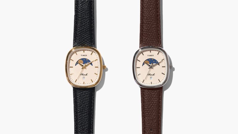 The Noah x Timex Oval Moon Phase Watch in a gold or silver plated case with a French vanilla dial and a central moon phase on croc leather strap.