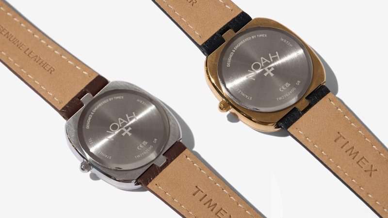 The Noah x Timex Oval Moon Phase Watch in a gold or silver plated case with a French vanilla dial and a central moon phase on croc leather strap.
