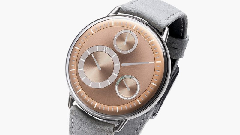 Ressence Type 1 Round Rose Gold limited-edition titanium watch with rose gold-plated dial, orbital ROCS display, and suede strap.