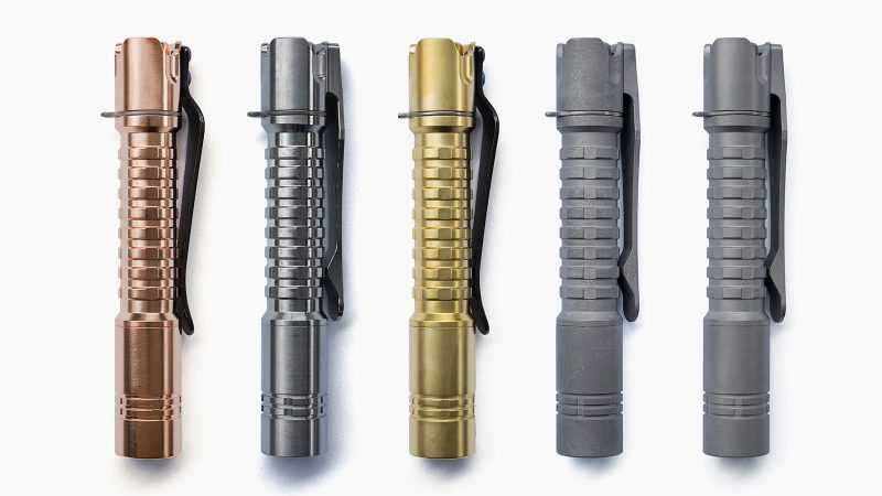 ReyLight Pineapple Mini MKIII Titanium Flashlight featuring a reverse clicky switch, titanium clip, and 4000K Nichia LED, showcased on a dark EDC gear setup.