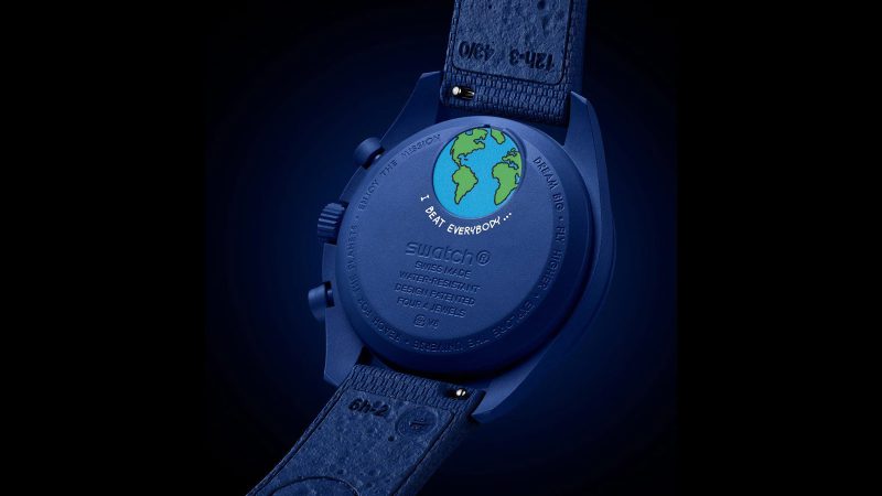 Navy SWATCH x Omega Mission to Earthphase Moonshine Gold Beaver Moon Edition watch with Earthphase, Moonshine Gold moonphase, Snoopy detail, and Bioceramic case.