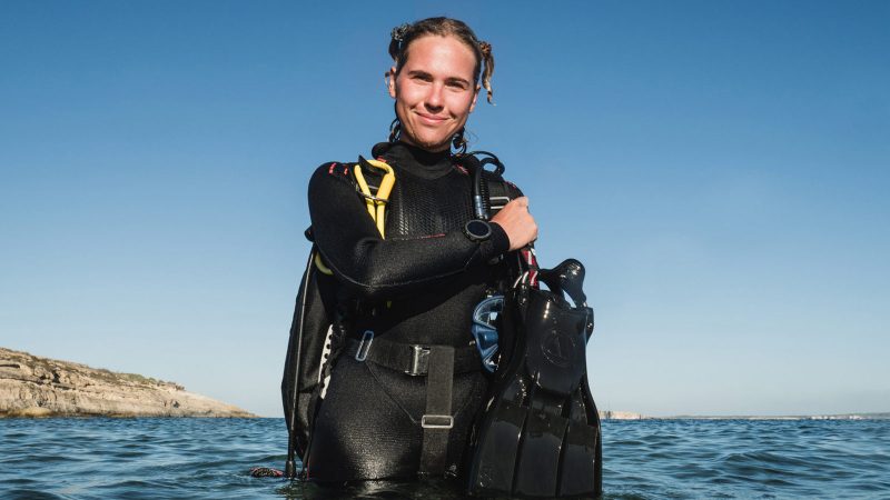 Suunto Nautic and Nautic S dive computers—large AMOLED display model and compact model—with rugged straps and deep-ocean interface styling.