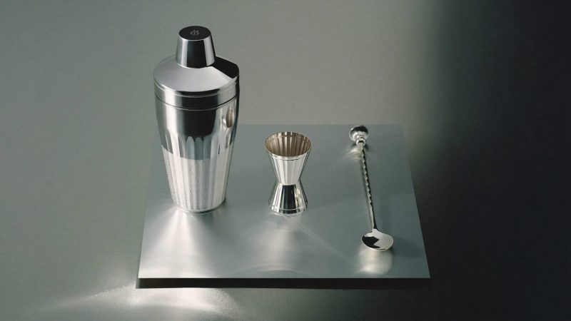 The RIMOWA x Robbe & Berking Cocktail Case features an aluminum shell, handcrafted silver bar tools, and a luxe travel mixology setup.