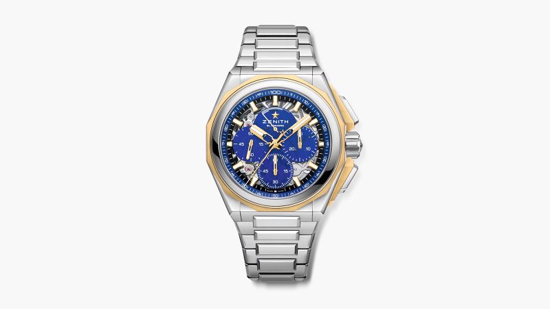 The Zenith DEFY Extreme Lapis Lazuli watch features a 45mm steel case with gold accents, a lapis stone dial, an openworked El Primero 9004 movement, and an included strap set.