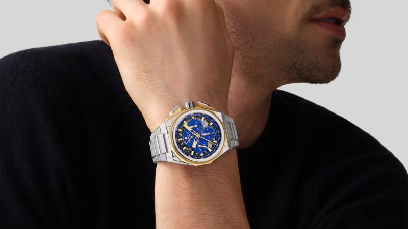 The Zenith DEFY Extreme Lapis Lazuli watch features a 45mm steel case with gold accents, a lapis stone dial, an openworked El Primero 9004 movement, and an included strap set.