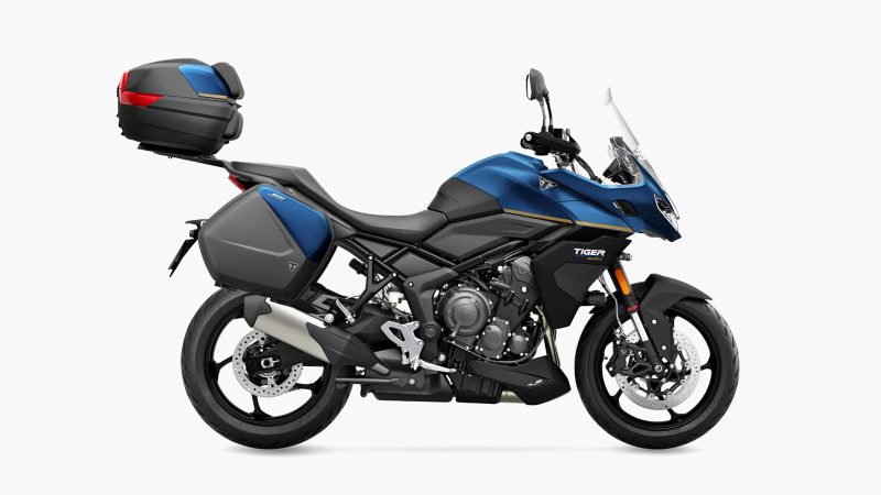 The 2026 Triumph Tiger Sport 800 Tour motorcycle with panniers, top case, 798cc triple engine, touring accessories, heated grips, comfort seat, TPMS, and Showa suspension.