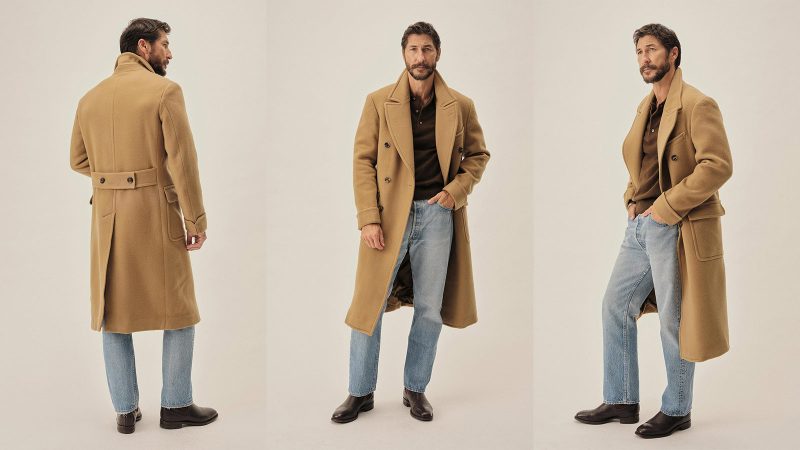 Buck Mason’s Camel Chukker Club Polo Coat in Italian wool features a double-breasted front, postbox pockets, and a classic tailored silhouette