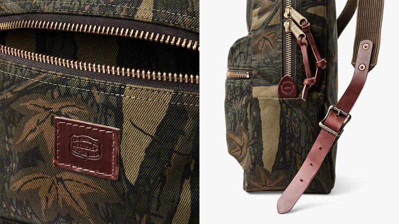 The Filson Workshop Rugged Twill Backpack in Maple Bark Camo with Harness Leather straps, brass zippers, padded back panel, and 15-inch laptop sleeve.
