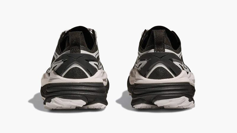 The HOKA Stinson One7 Dover Street Market collaboration sneaker features maximal cushioning, monochrome design, all-terrain sole, and high-fashion trail aesthetic.