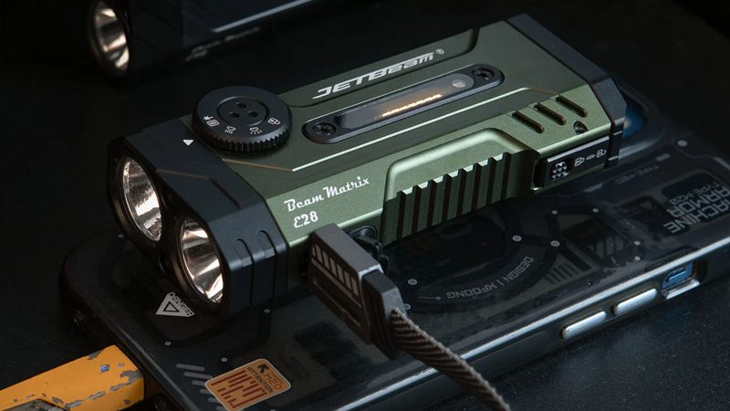 The JETBEAM E28 tactical EDC flashlight in black aero-grade aluminum with a stainless steel pocket clip and high-intensity Luminus LED lens.