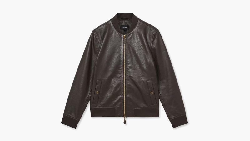 The REISS Cast leather bomber jacket features grained leather, gold-tone hardware, ribbed trims, and a modern minimalist silhouette.