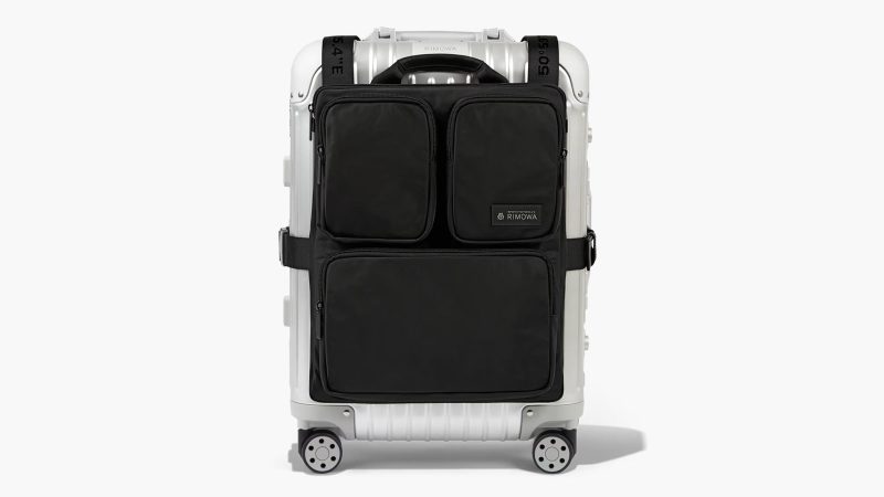 The RIMOWA Cabin Luggage Harness Backpack in recycled nylon with adjustable suitcase straps, hidden shoulder straps, dual laptop pockets, and modular travel organization.