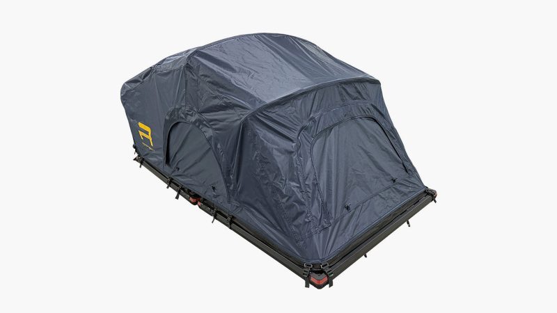The Roofnest Meadowlark ultralight rooftop tent is mounted on a compact SUV, featuring an open fold-out design with an integrated ladder and foam mattress.