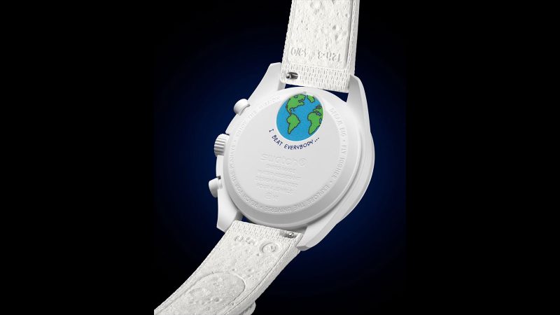 Swatch Mission to Earthphase Moonshine Gold Cold Moon Bioceramic chronograph with UV-glowing Earthphase, Snoopy moon illustration, Moonshine™ Gold moonphase, white opaline dial, and Super-LumiNova markers.