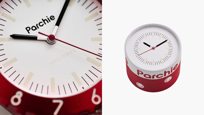 The Parchie Lunar-Time Limited Edition for Hodinkee is a space-inspired watch with a red aluminum case, a white dial, a Velcro strap, and available in 32mm and 36mm sizes.