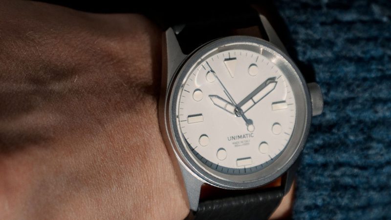 The UNIMATIC Italian Alps Collection watches with Alpine Sky Blue and Glacier White dials, 3D UNILIGHT lume markers, fumo deer leather straps, and 316L steel cases.