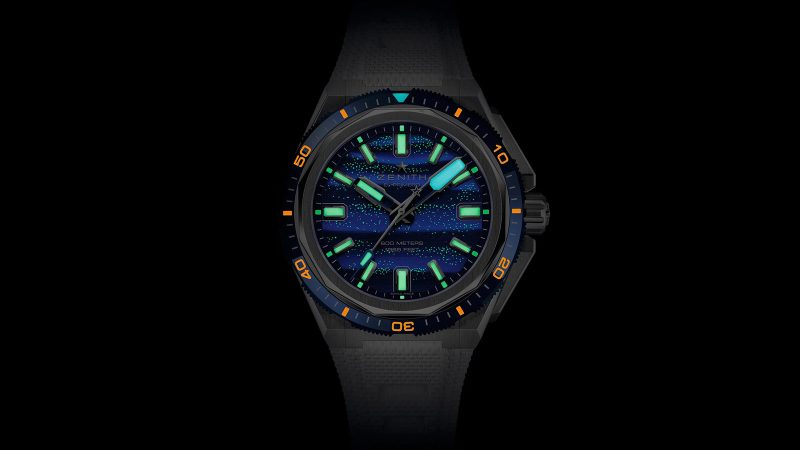 The Zenith DEFY Extreme Diver Bioluminescence Topper Limited Edition titanium dive watch with blue glowing Super-LumiNova dial, El Primero movement, and 600m water resistance.