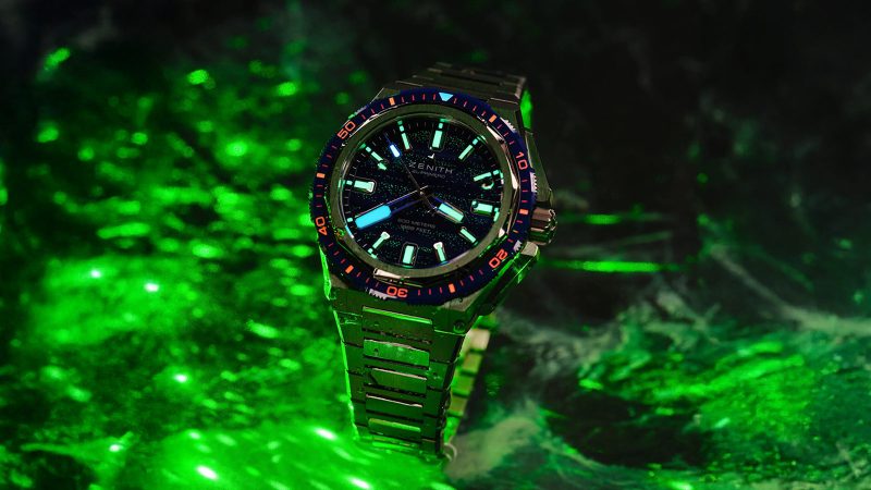 The Zenith DEFY Extreme Diver Bioluminescence Topper Limited Edition titanium dive watch with blue glowing Super-LumiNova dial, El Primero movement, and 600m water resistance.