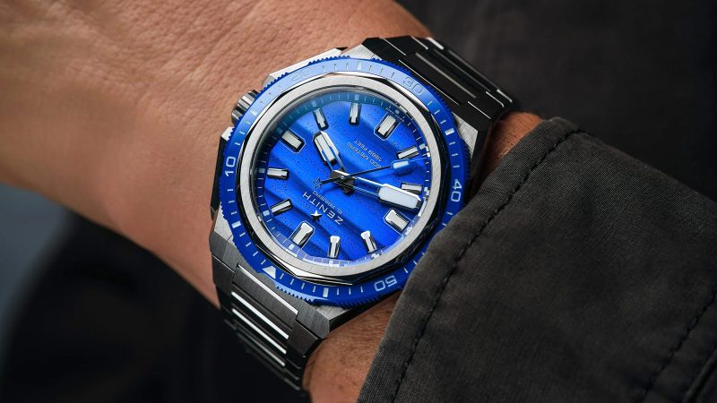The Zenith DEFY Extreme Diver Bioluminescence Topper Limited Edition titanium dive watch with blue glowing Super-LumiNova dial, El Primero movement, and 600m water resistance.